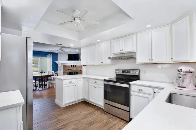 a kitchen with white cabinets and white appliances