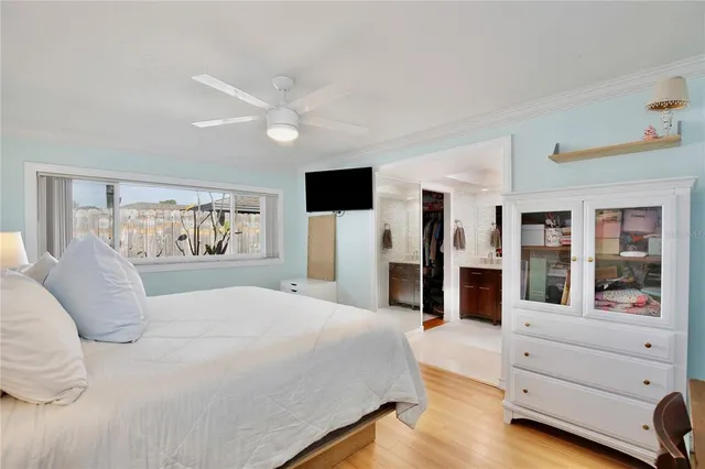 a spacious bedroom with a large bed and painting on the wall