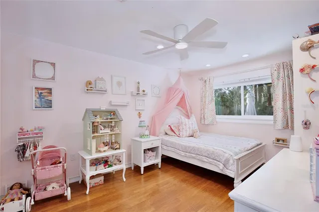 a bedroom with furniture and a wooden floor