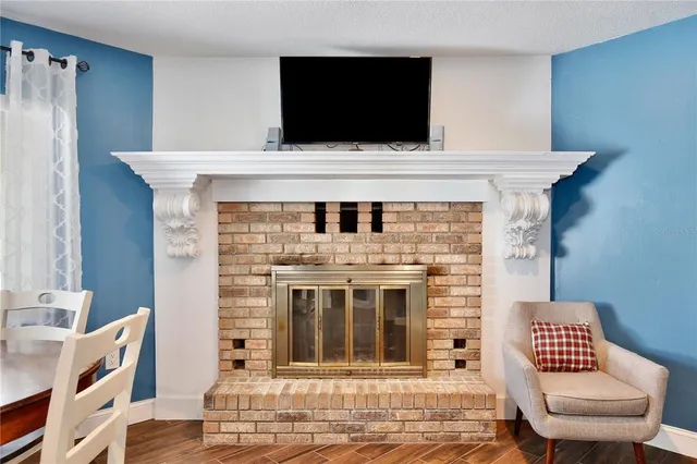 a living room with a fireplace and a flat screen tv