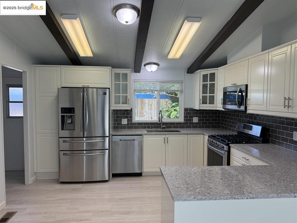 841 West Brannan Island Road, Unit 3 Isleton, CA 95641 - Photo 3 of 7 a kitchen with stainless steel appliances a refrigerator a sink a stove and cabinets