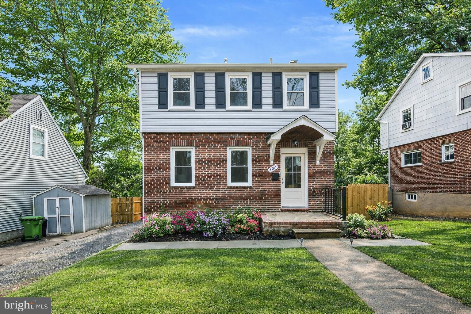 a front view of a house with a garden and yard