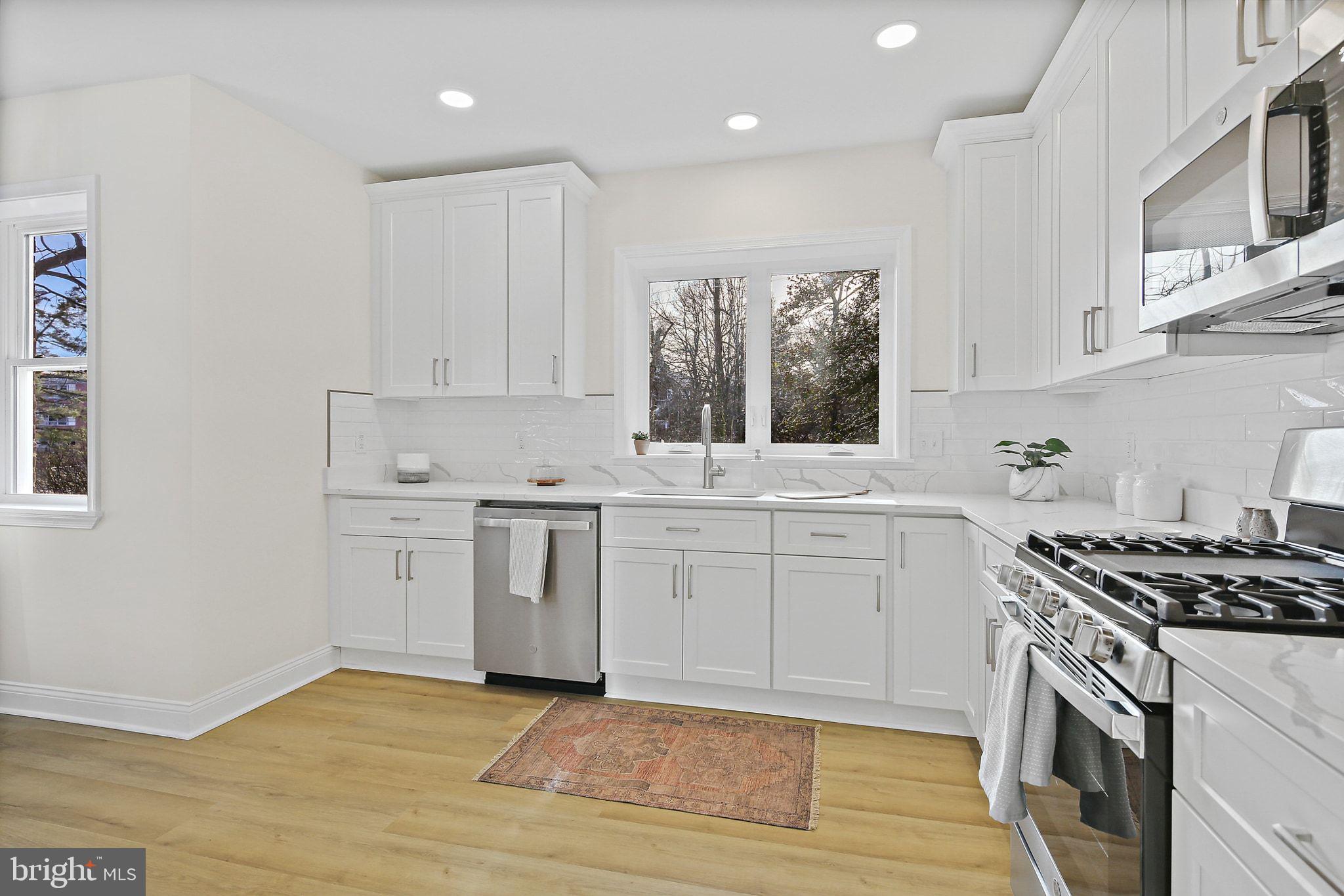402 Westgate Road Baltimore, MD 21229 - Photo 13 of 37 a kitchen with a stove oven and sink