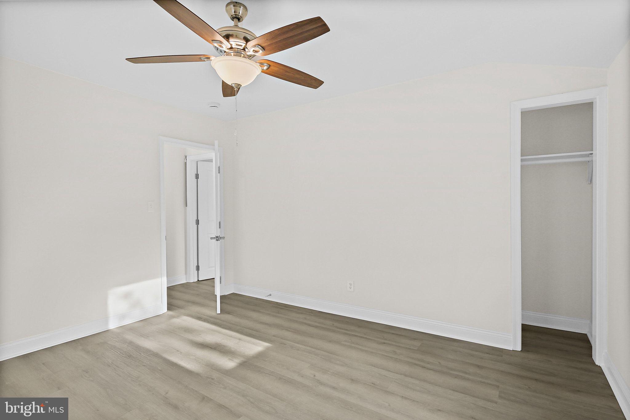 402 Westgate Road Baltimore, MD 21229 - Photo 19 of 37 a view of a room with wooden floor and a ceiling fan