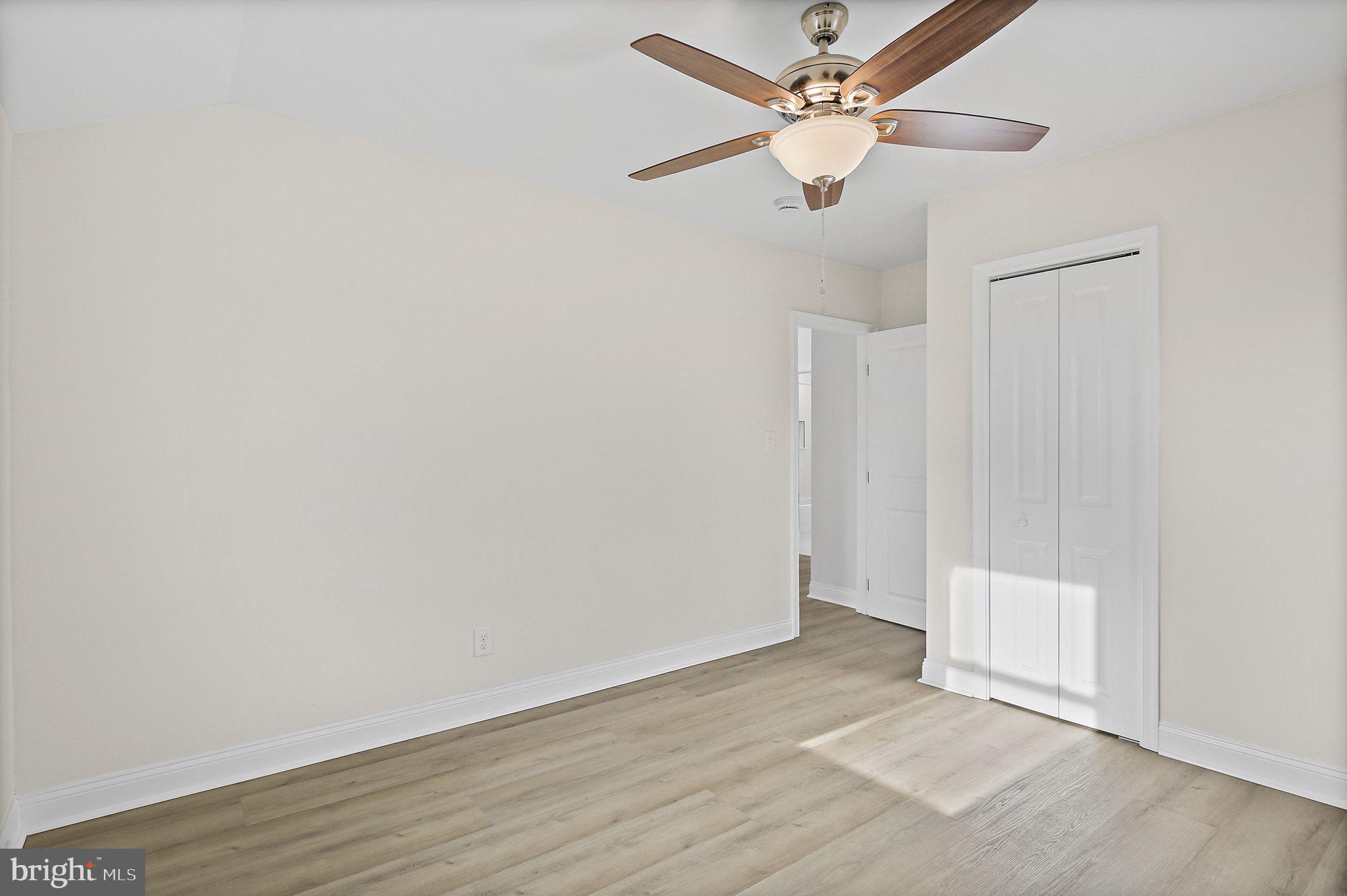 402 Westgate Road Baltimore, MD 21229 - Photo 21 of 37 an empty room with wooden floor ceiling fan and window