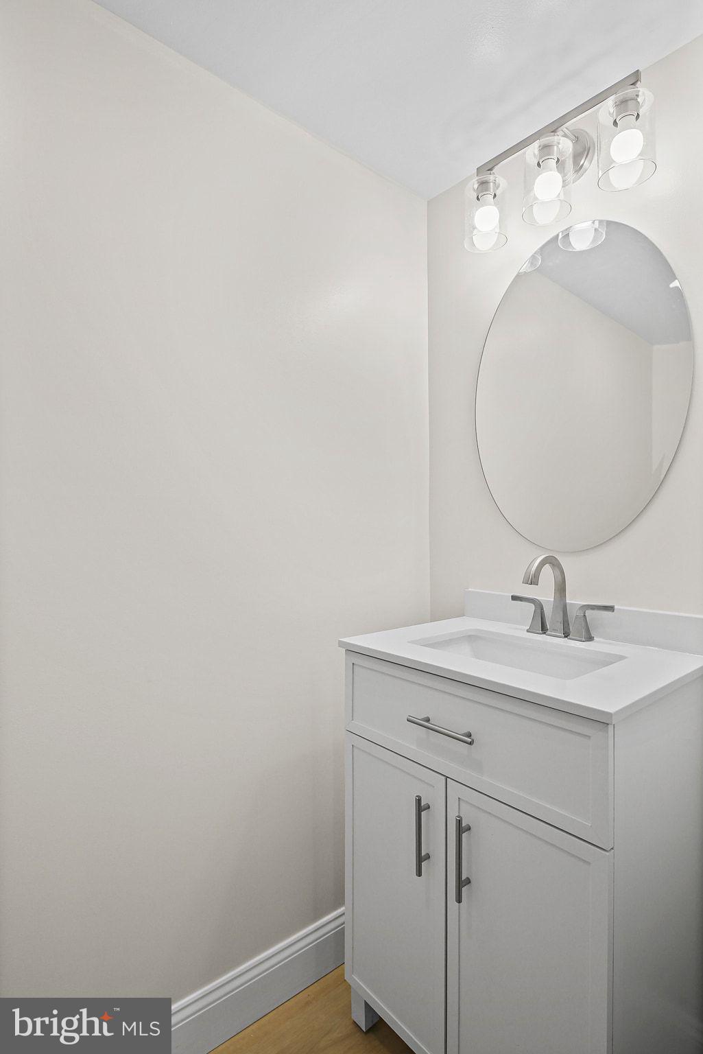 402 Westgate Road Baltimore, MD 21229 - Photo 25 of 37 a bathroom with a sink and mirror