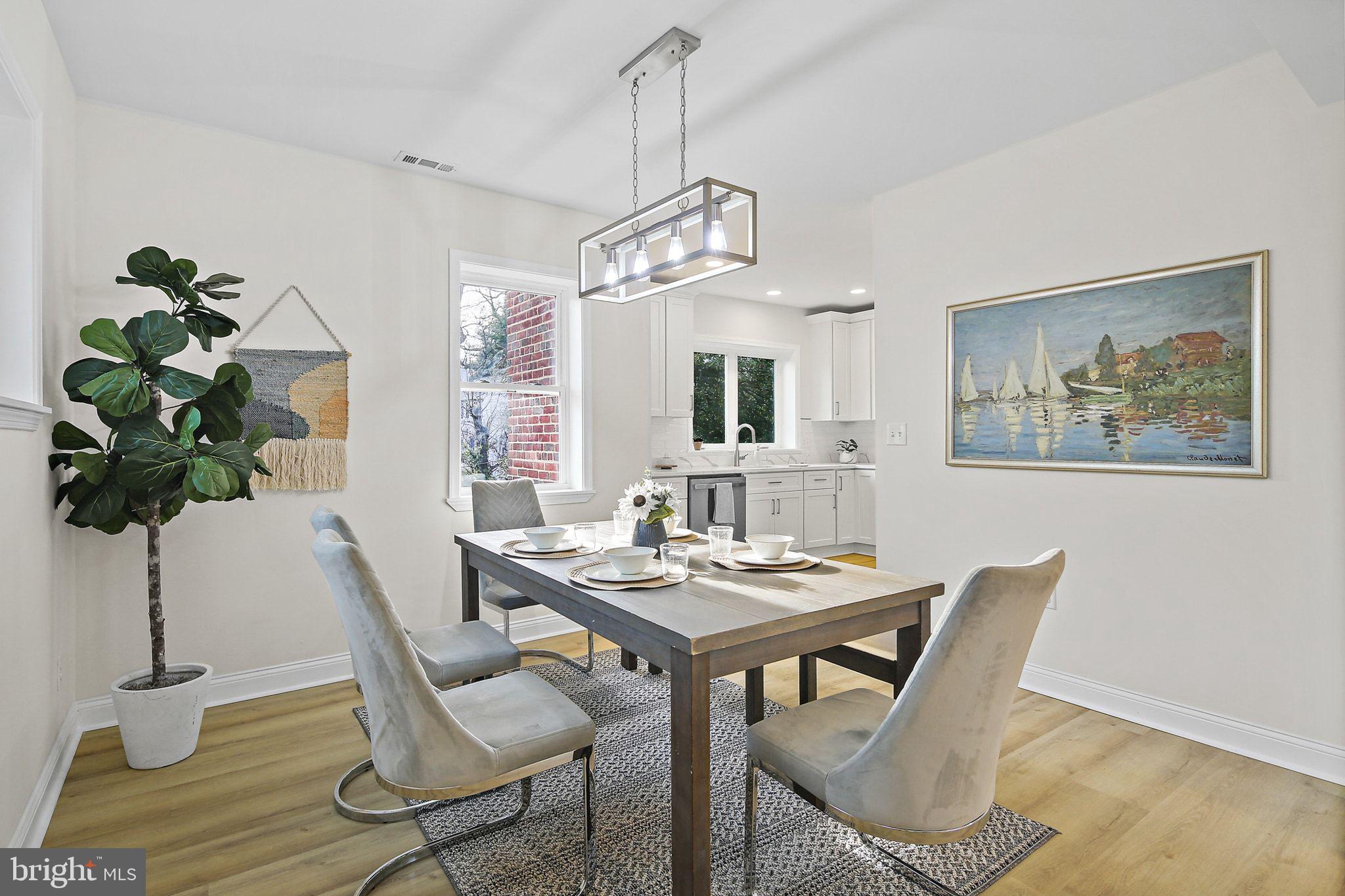 402 Westgate Road Baltimore, MD 21229 - Photo 9 of 37 a dining room with furniture potted plants and wooden floor