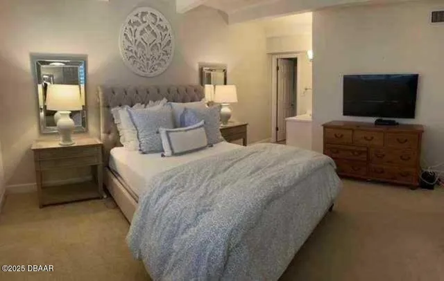 a bedroom with bed and flat screen tv