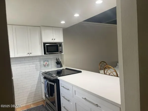 a kitchen with a sink a stove and microwave