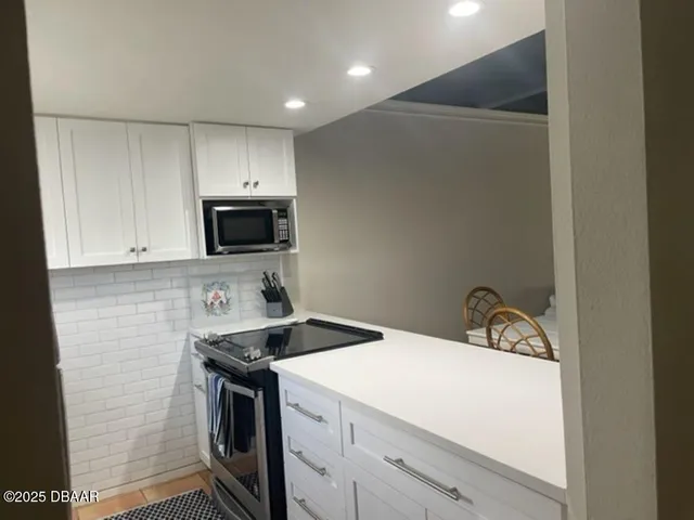a kitchen with a sink a stove and microwave