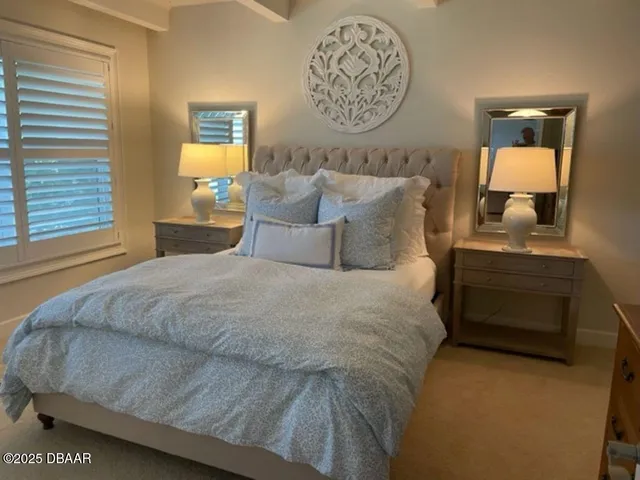 a bedroom with bed and paintings on the wall