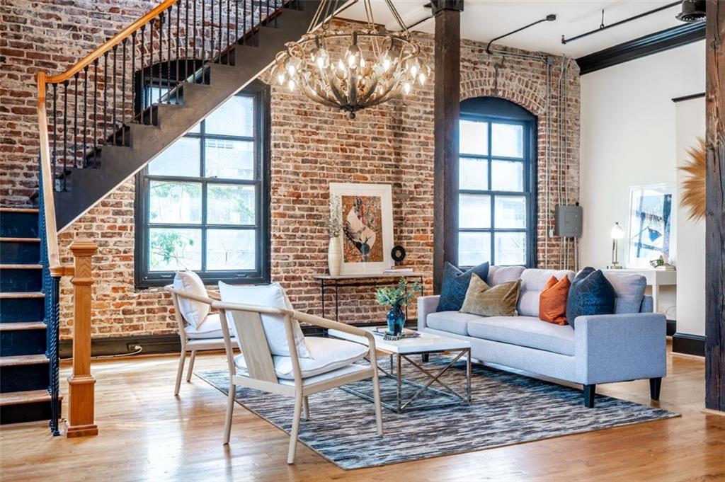 215 Mitchell Street Southwest, Unit 10 Atlanta, GA 30303 - Photo 1 of 1 a living room with furniture and a window