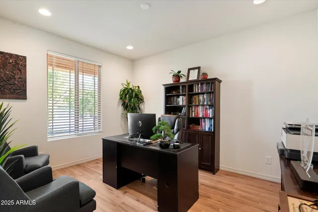 a living room with furniture and a book shelf