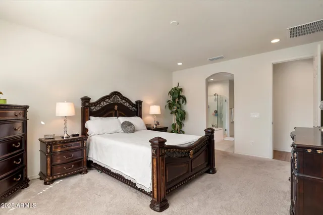 a bedroom with a bed and a television