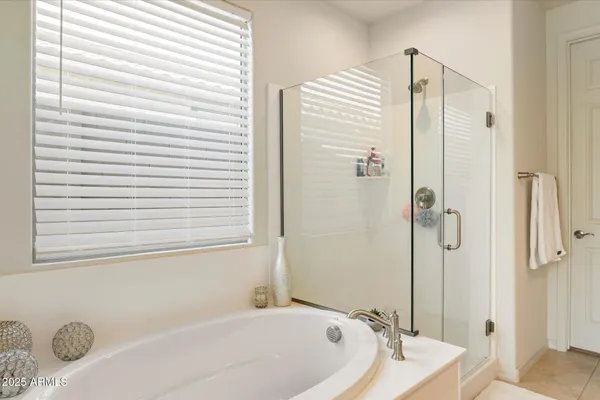 a bathroom with a granite countertop bathtub and shower