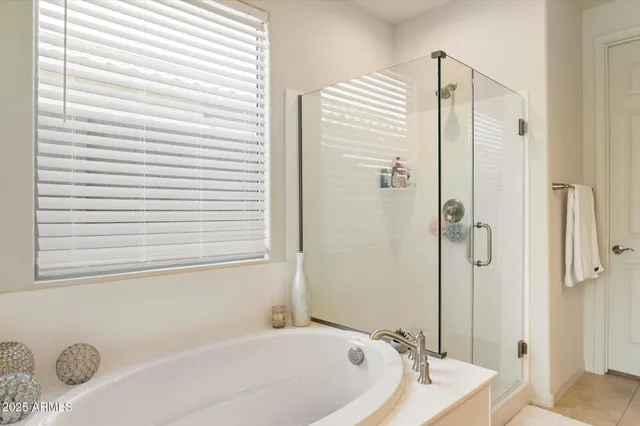 a bathroom with a granite countertop bathtub and shower