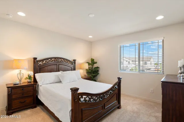 a bed sitting in a bedroom next to a window