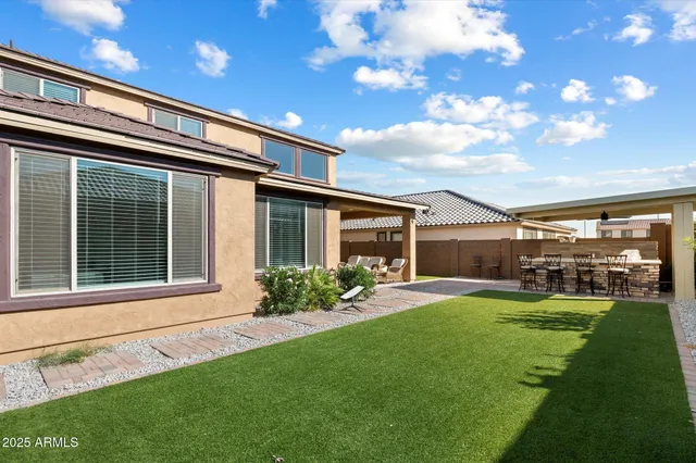 a view of a house with a yard and sitting area