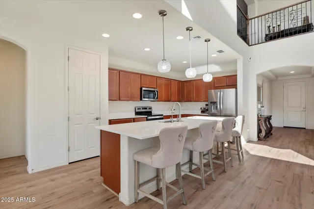 a large kitchen with a table and chairs