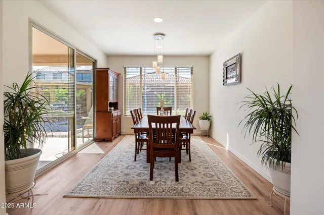 a dining room with furniture window and wooden floor