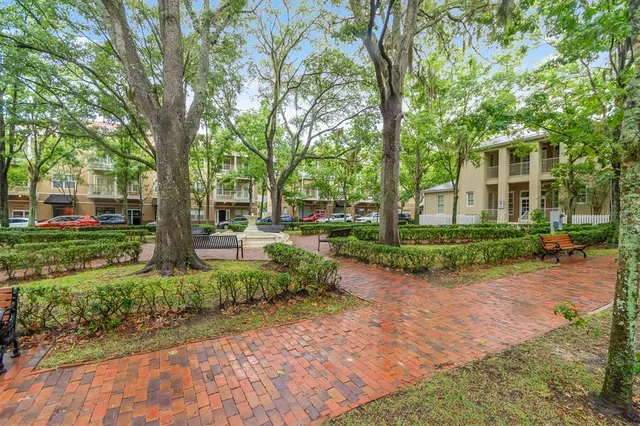 a front view of a house with a yard and an trees