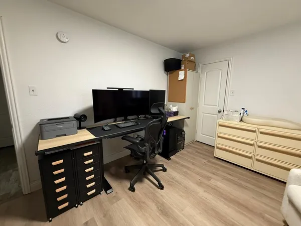 a view of a workspace with furniture and a flat screen tv