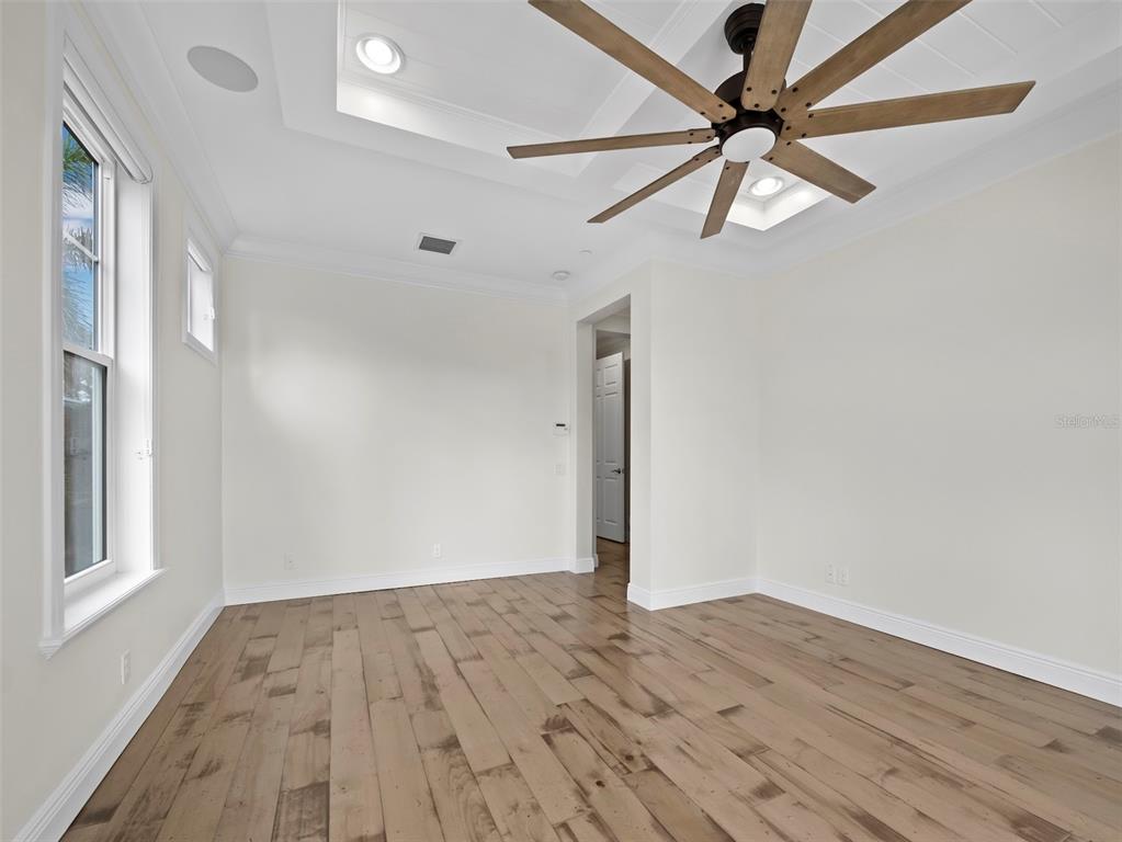 333 Firehouse Court Longboat Key, FL 34228 - Photo 14 of 83 a view of empty room with wooden floor and fan