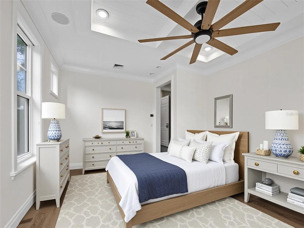 333 Firehouse Court Longboat Key, FL 34228 - Photo 15 of 83 a bedroom with a large bed and a chandelier