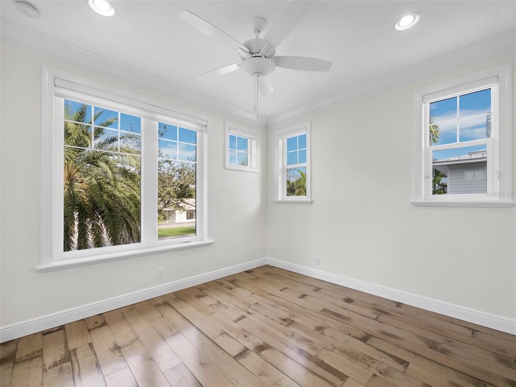 333 Firehouse Court Longboat Key, FL 34228 - Photo 24 of 83 a view of empty room with wooden floor and fan