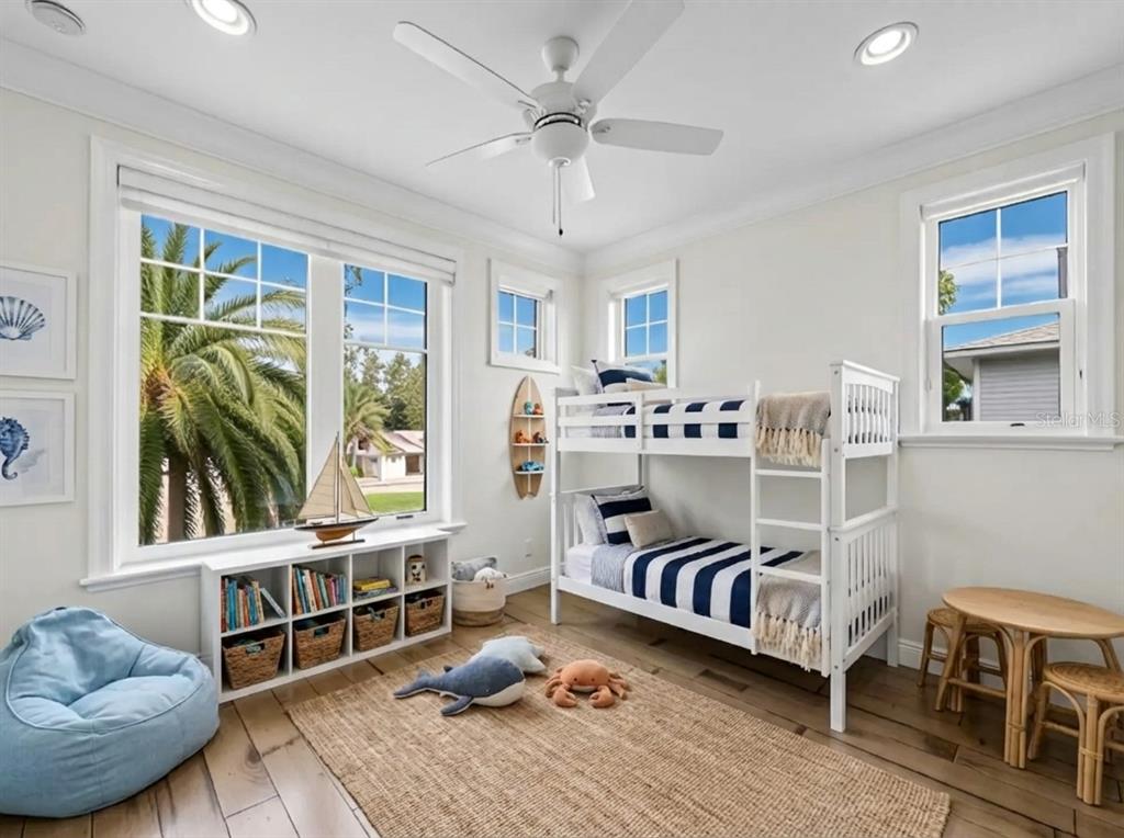 333 Firehouse Court Longboat Key, FL 34228 - Photo 25 of 83 a bedroom with furniture and a large window