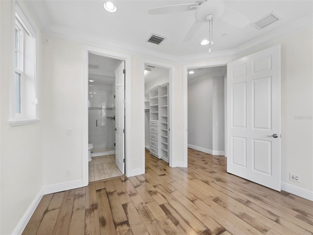 333 Firehouse Court Longboat Key, FL 34228 - Photo 26 of 83 an empty room with wooden floor and windows