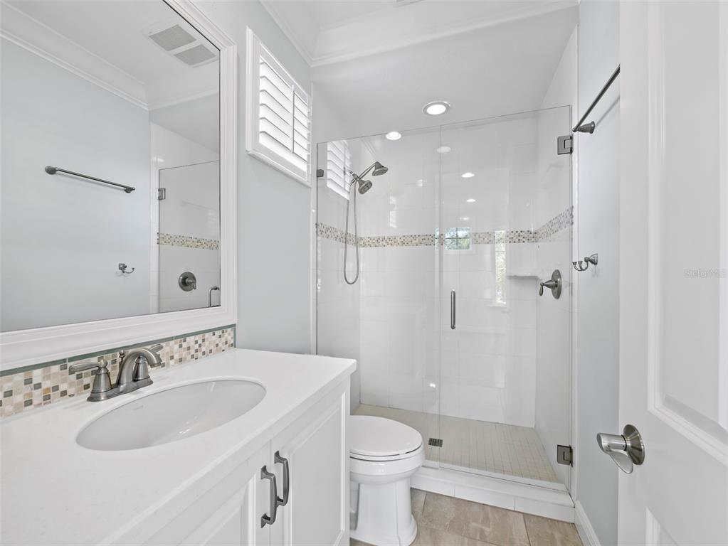 333 Firehouse Court Longboat Key, FL 34228 - Photo 27 of 83 a bathroom with a sink toilet a mirror and shower
