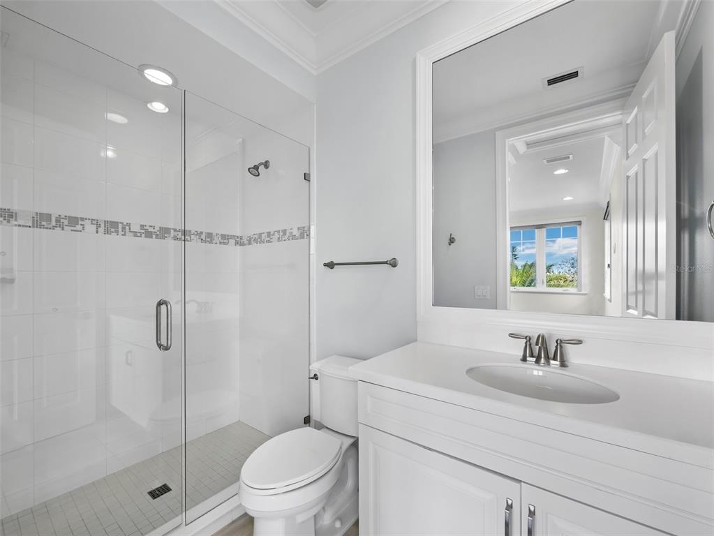 333 Firehouse Court Longboat Key, FL 34228 - Photo 33 of 83 a bathroom with a sink toilet and shower
