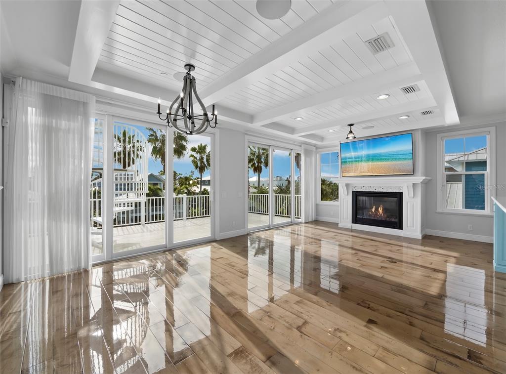 333 Firehouse Court Longboat Key, FL 34228 - Photo 4 of 83 a living room with fireplace furniture and a chandelier