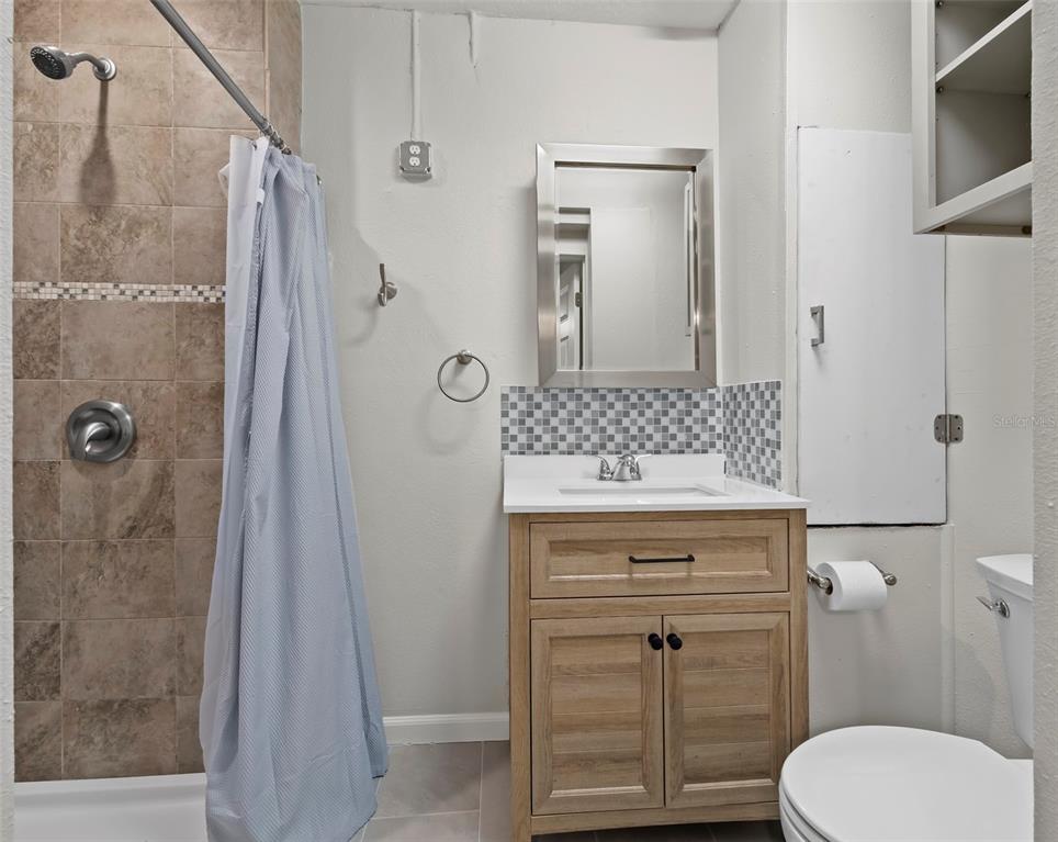 333 Firehouse Court Longboat Key, FL 34228 - Photo 45 of 83 a bathroom with a granite countertop shower a toilet and a sink