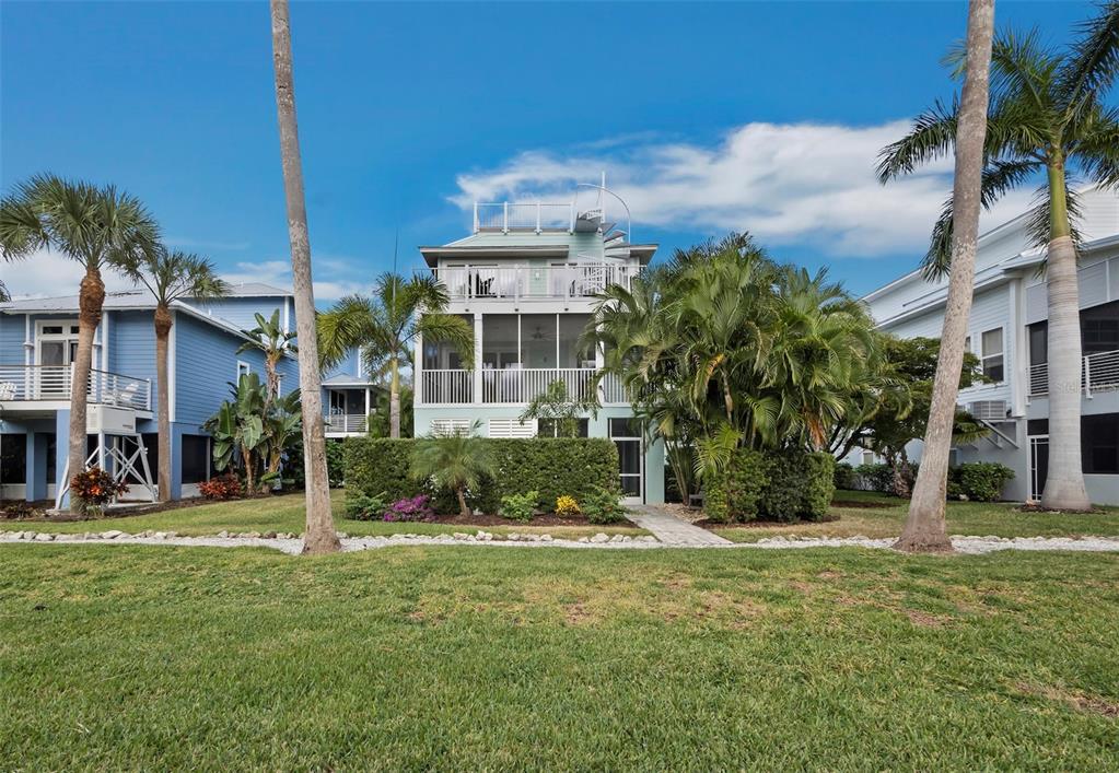 333 Firehouse Court Longboat Key, FL 34228 - Photo 49 of 83 a view of a house with a yard