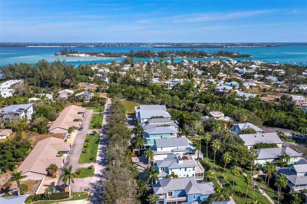 333 Firehouse Court Longboat Key, FL 34228 - Photo 61 of 83 an aerial view of a city with lots of residential buildings and ocean view in back