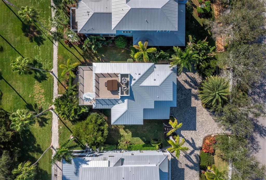 333 Firehouse Court Longboat Key, FL 34228 - Photo 64 of 83 an aerial view of a house with yard and outdoor seating