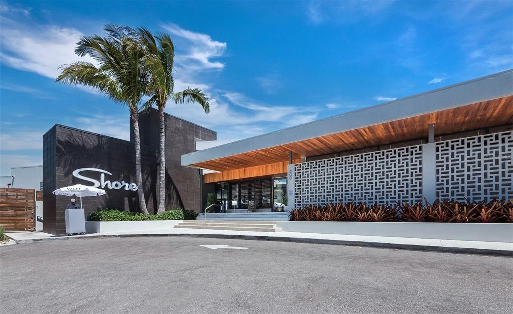 333 Firehouse Court Longboat Key, FL 34228 - Photo 77 of 83 a vase of flowers sitting on a floor in front of a building
