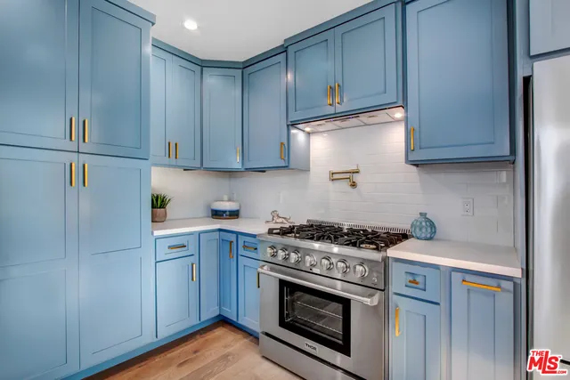 a kitchen with a stove and a sink