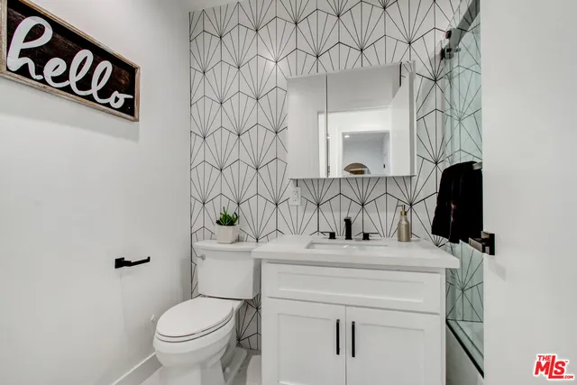 a bathroom with a sink toilet and mirror