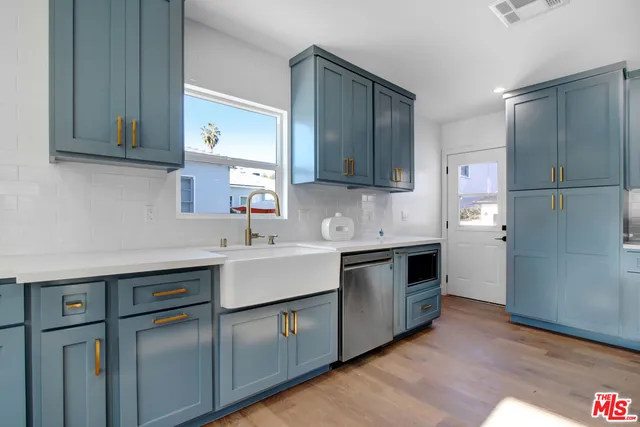 a kitchen with a sink cabinets and appliances