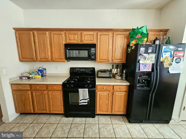 a kitchen with stainless steel appliances granite countertop a refrigerator stove and sink
