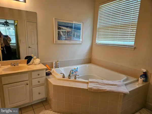 a bath tub sitting in a bathroom next to a bathroom
