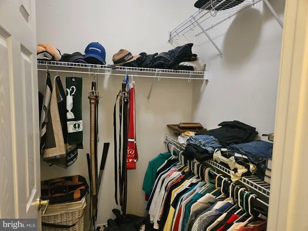 a view of walk in closet with clothes
