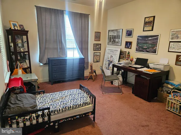 a bedroom with a bed and a desk