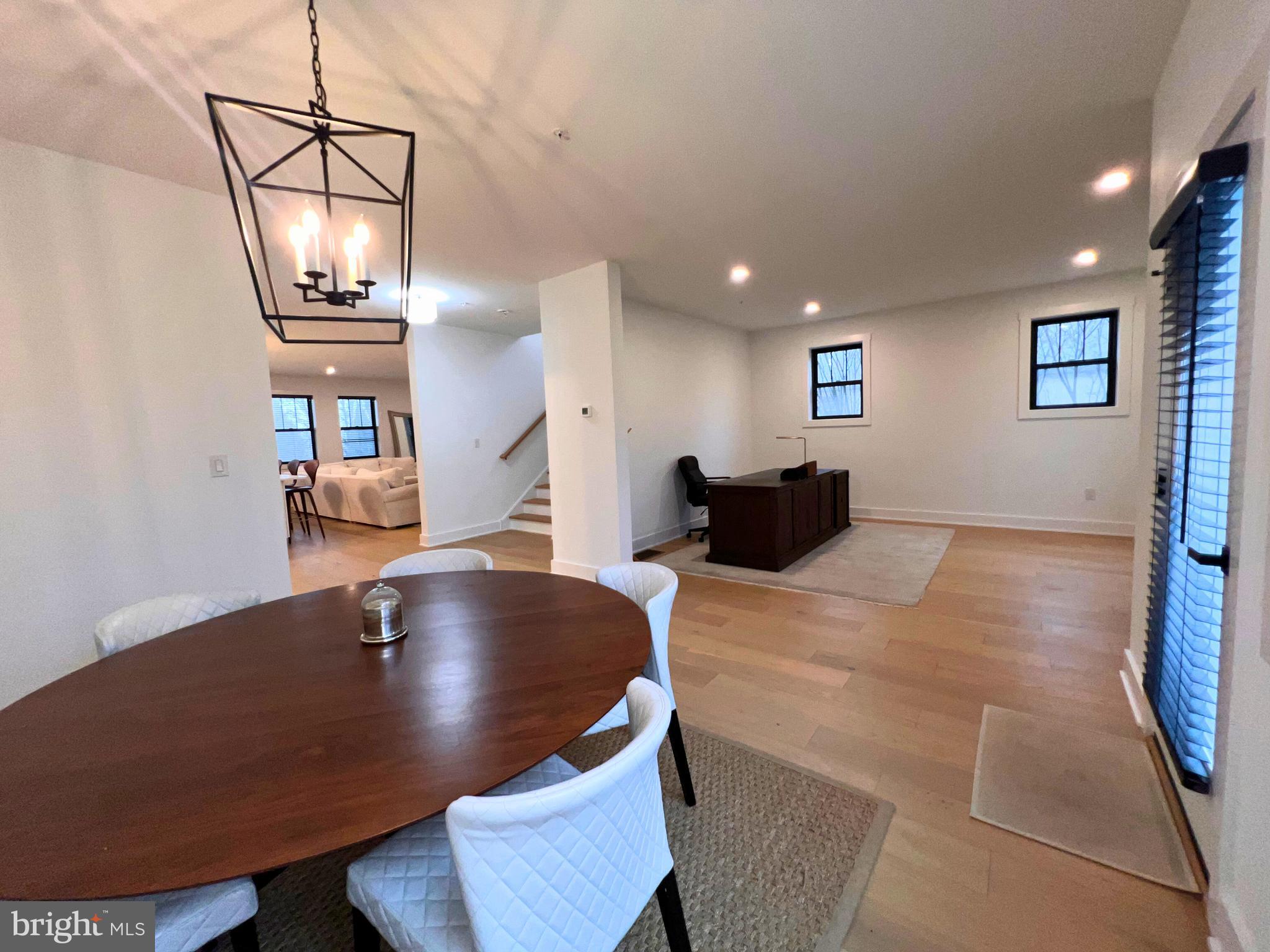 986 Henry Avenue Wayne, PA 19087 - Photo 11 of 32 a view of dining room and livingroom with furniture wooden floor a rug and a chandelier