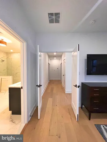 a bathroom with a double vanity sink mirror and shower