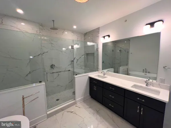 a bathroom with a sink a toilet and bathtub