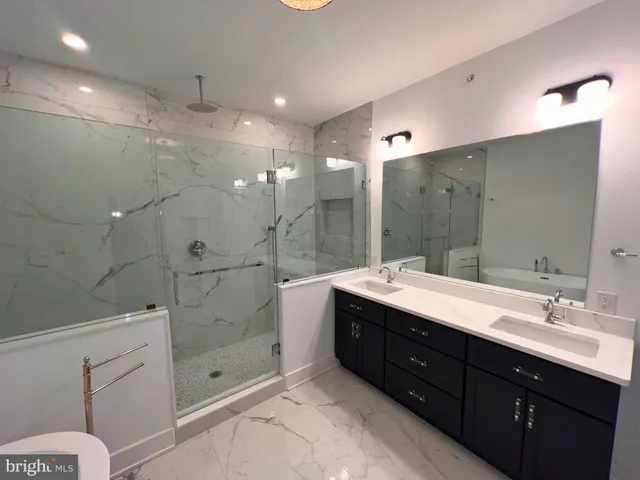 a bathroom with a sink a toilet and bathtub